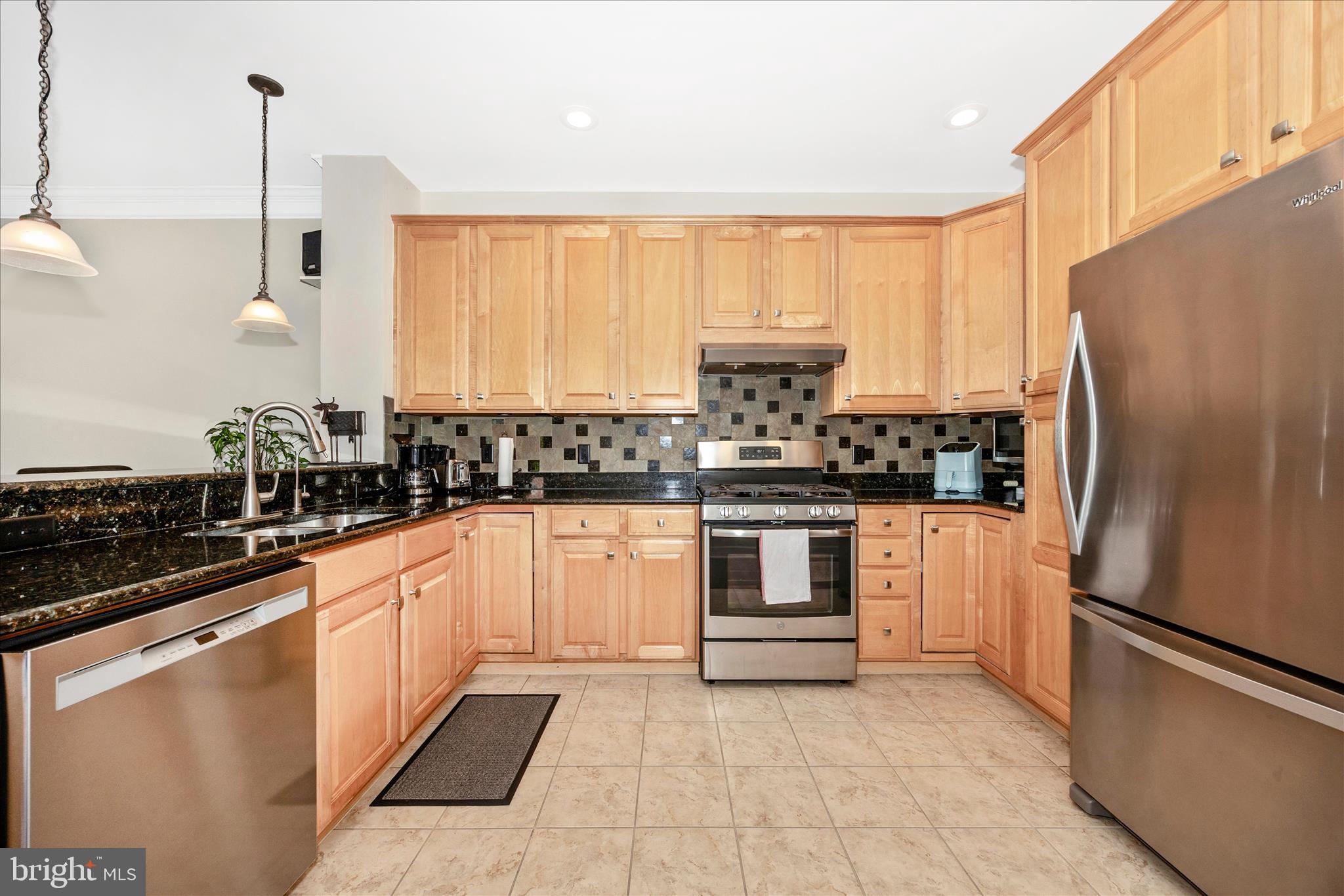 35 East All Saints Street, Unit 211 Frederick, MD 21701 - Photo 29 of 61 a kitchen with stainless steel appliances a refrigerator sink and stove top oven