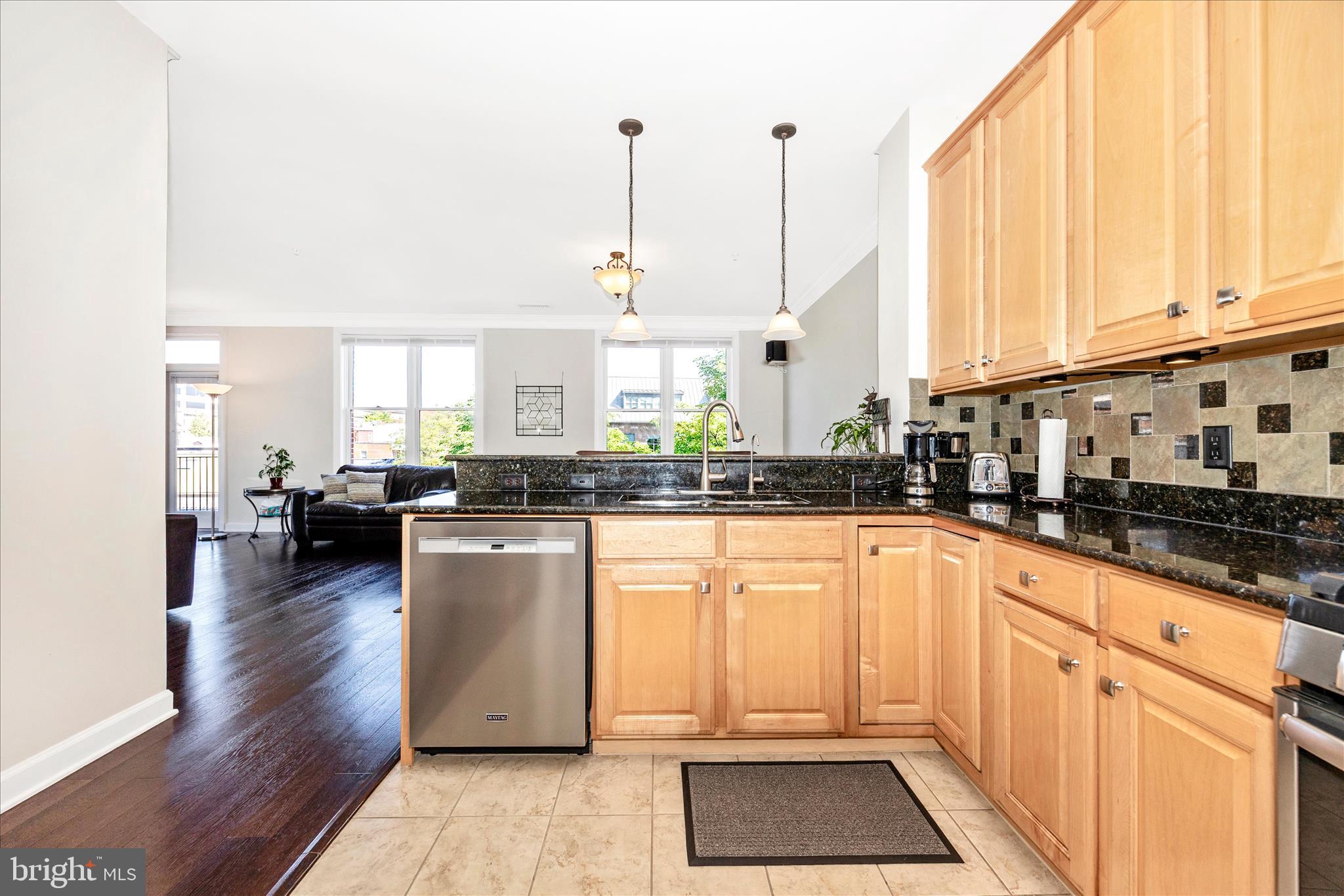 35 East All Saints Street, Unit 211 Frederick, MD 21701 - Photo 31 of 61 a kitchen with stainless steel appliances granite countertop a stove a sink and white cabinets with wooden floor