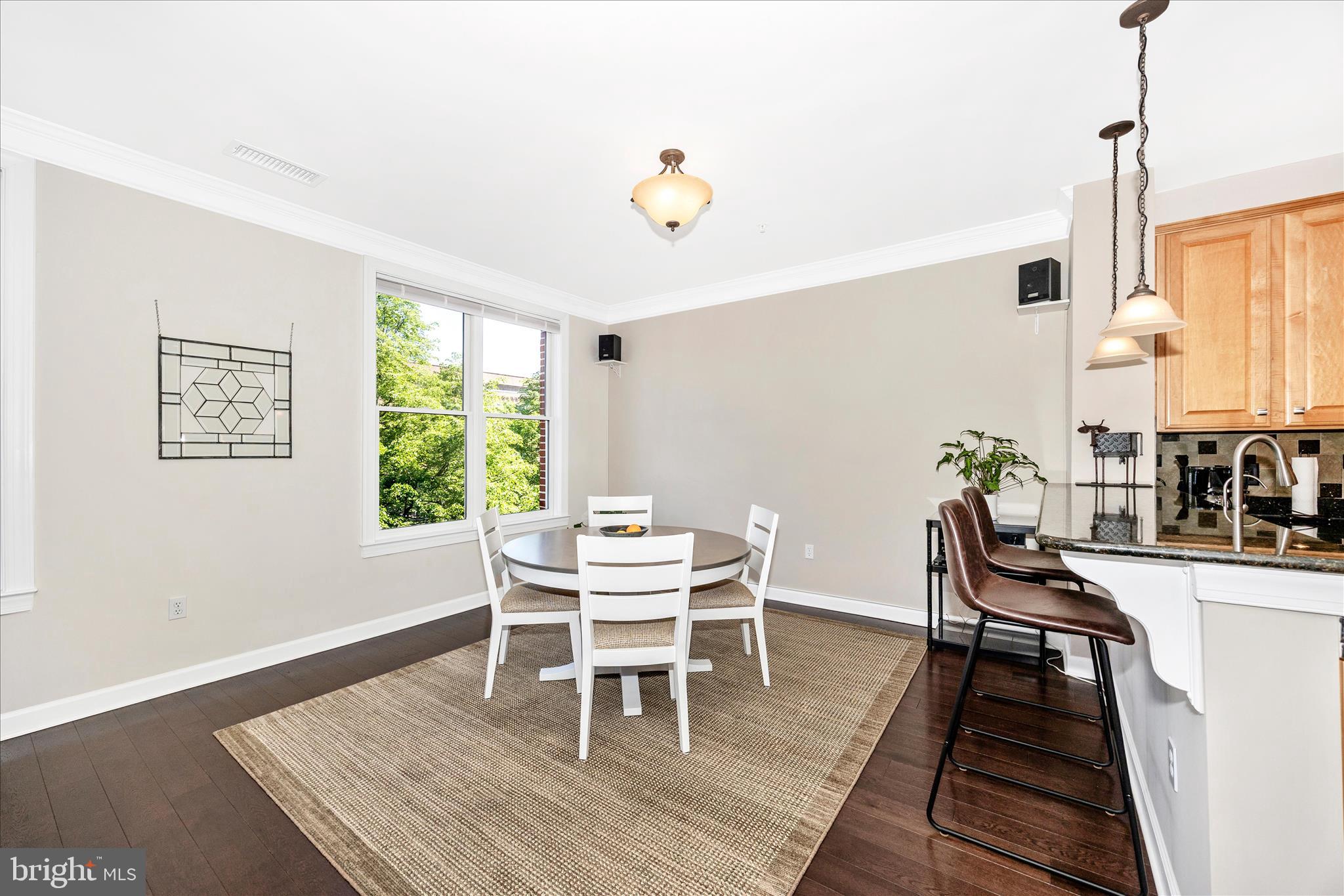 35 East All Saints Street, Unit 211 Frederick, MD 21701 - Photo 36 of 61 a dining room with furniture and wooden floor