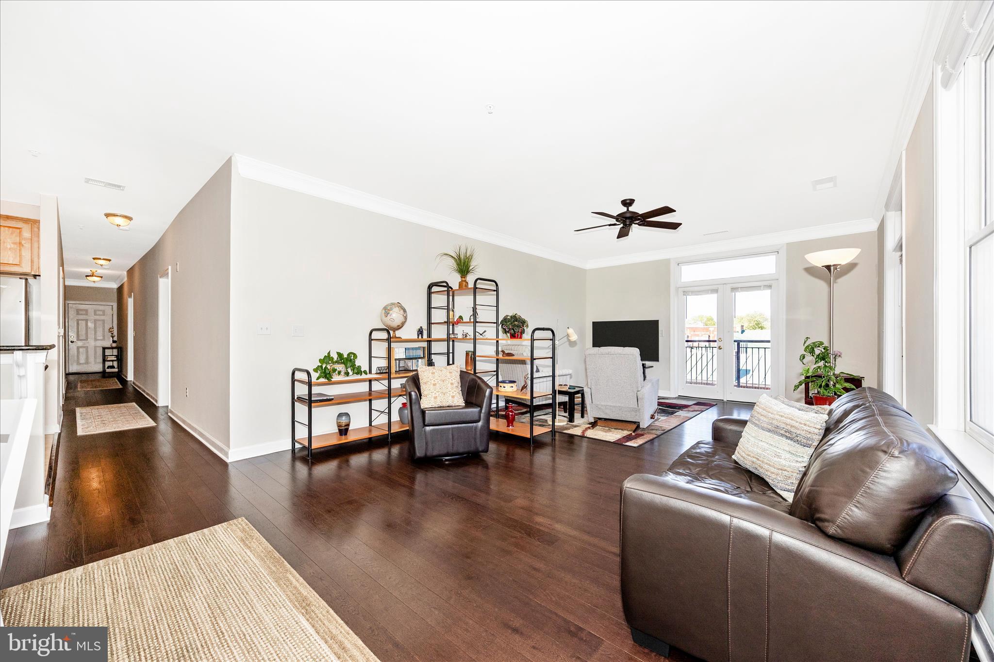 35 East All Saints Street, Unit 211 Frederick, MD 21701 - Photo 39 of 61 a living room with furniture and a wooden floor