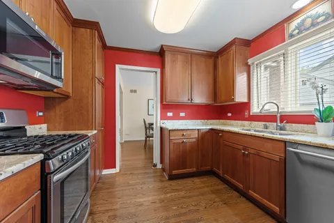 a kitchen with granite countertop a sink stove and cabinets