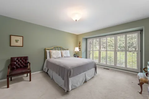 a bedroom with a bed and a chair