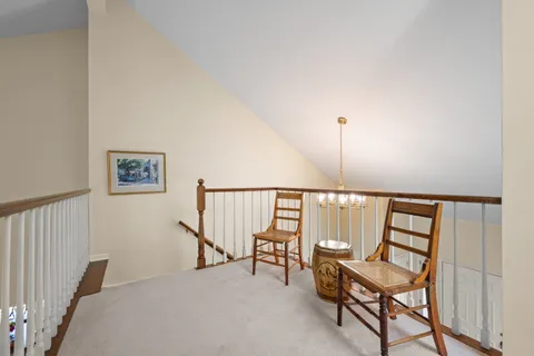 a view of staircase with furniture and window