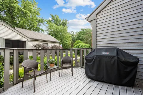a view of deck with table and chairs and wooden floor