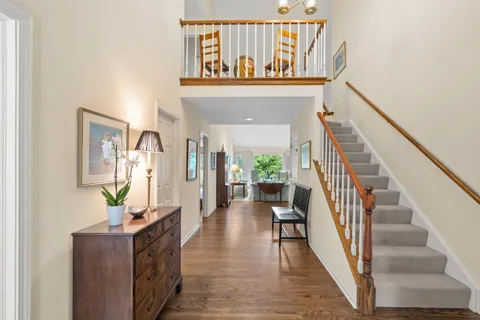 a view of entryway and hall with wooden floor