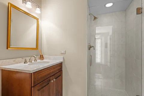 a bathroom with a sink vanity and a mirror