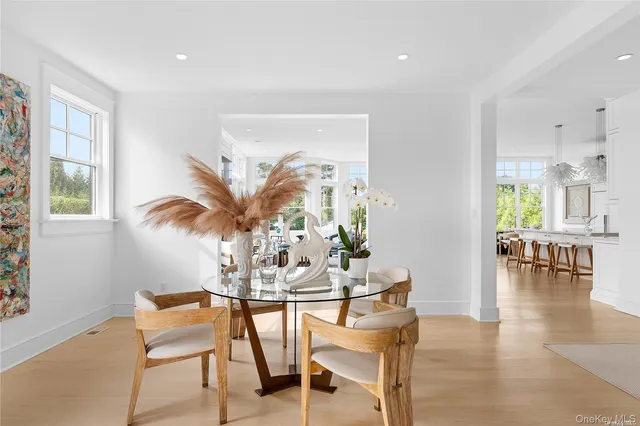 a view of a dining room with furniture and a potted plant