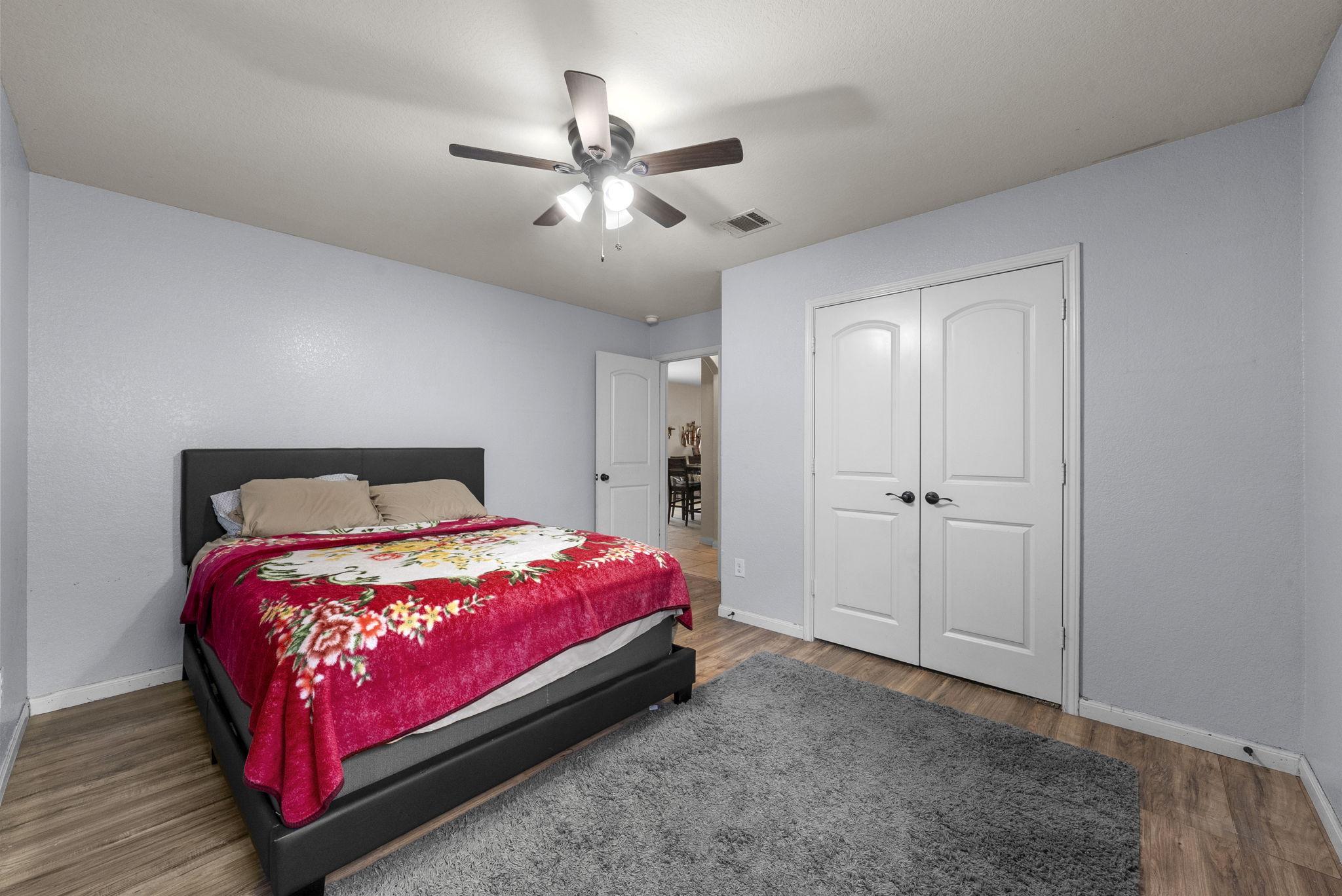 1617 Treeta Trail Kyle, TX 78640 - Photo 24 of 39 Bedroom with a ceiling fan, wood finished floors, and a closet