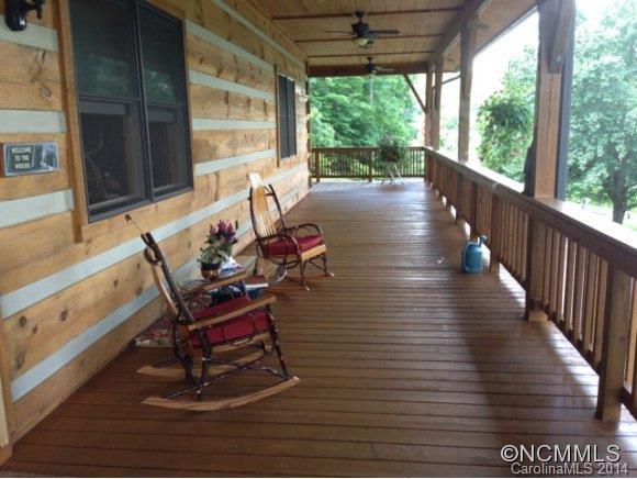 411 Jess Cove Road Clyde, NC 28721 - Photo 14 of 24 a view of a patio with wooden floor and outdoor seating