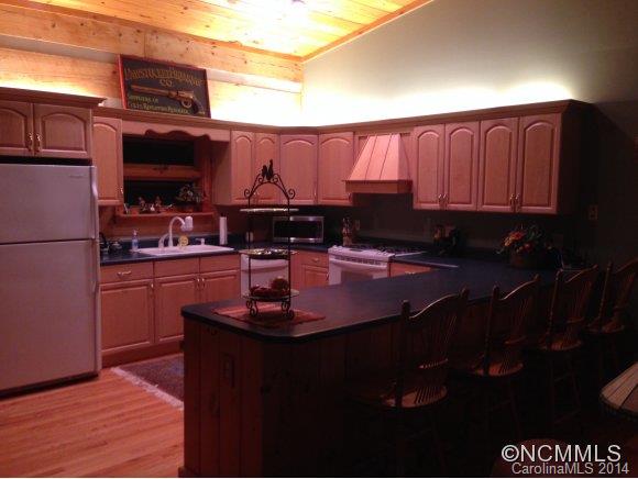 411 Jess Cove Road Clyde, NC 28721 - Photo 3 of 24 a kitchen with a sink and cabinets