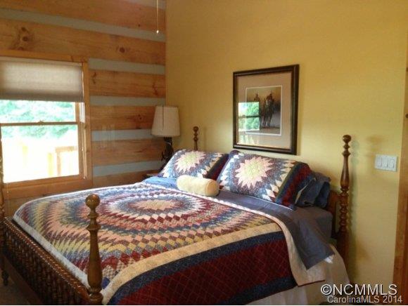 411 Jess Cove Road Clyde, NC 28721 - Photo 8 of 24 a bedroom with a bed and window