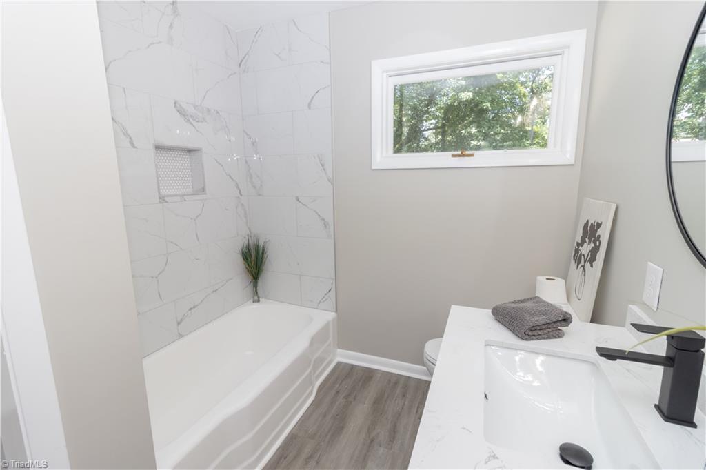 2216 Lane Road Greensboro, NC 27408 - Photo 12 of 38 BATHROOM: THE TUB WAS NOT TAKEN OUT, WE ID THE SURROUND,