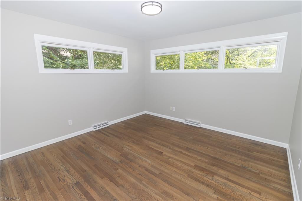 2216 Lane Road Greensboro, NC 27408 - Photo 15 of 38 FRONT CORNER BEDRROM: REFINISHED FLOORS AND ALL NEW PAINT AND LIGHTS.