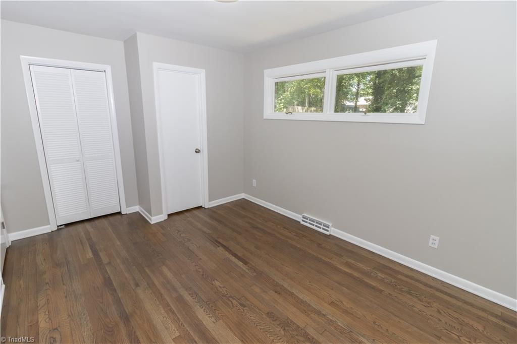 2216 Lane Road Greensboro, NC 27408 - Photo 19 of 38 PRIMARY BEDROOM.. THE RIGHT DOOR IS TO THE HALF BATH AND THE LEFT DOOR IS TO THE CLOSET.