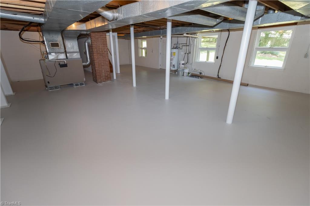 2216 Lane Road Greensboro, NC 27408 - Photo 24 of 38 BASEMENT: TO THE RIGHT AT THE WATER HEATER IS THE WASHER AND DRYER AREA.