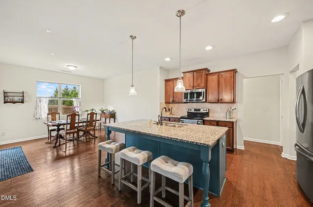 a living room with fireplace furniture and a wooden floor