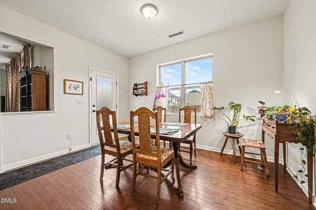 a kitchen with stainless steel appliances granite countertop a kitchen island hardwood floor sink stove and refrigerator
