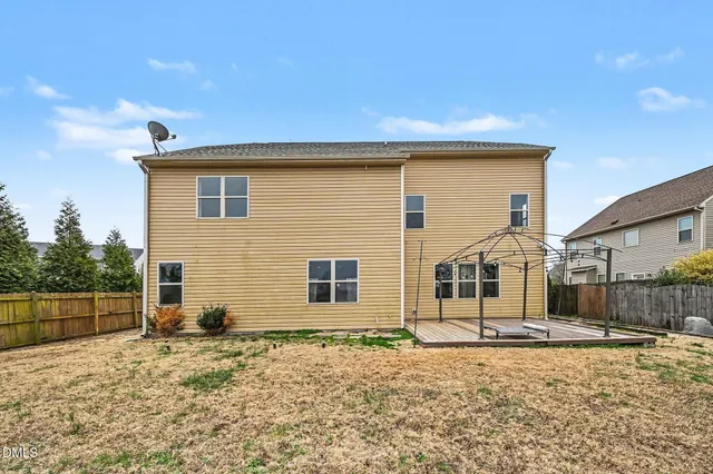 a view of a house with snow on the road