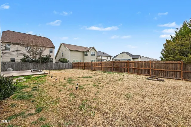 a backyard of a house with wooden fence