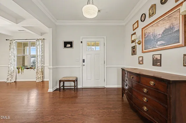 a front view of a house with a garden and mountain view