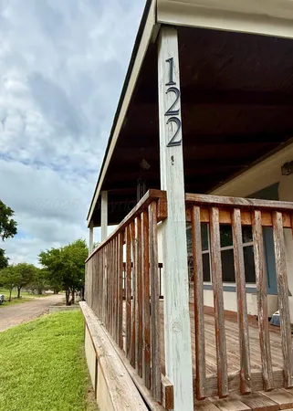 a view of an house with backyard and sitting area