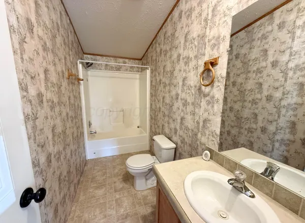 a view of a livingroom with wooden floor and stairs