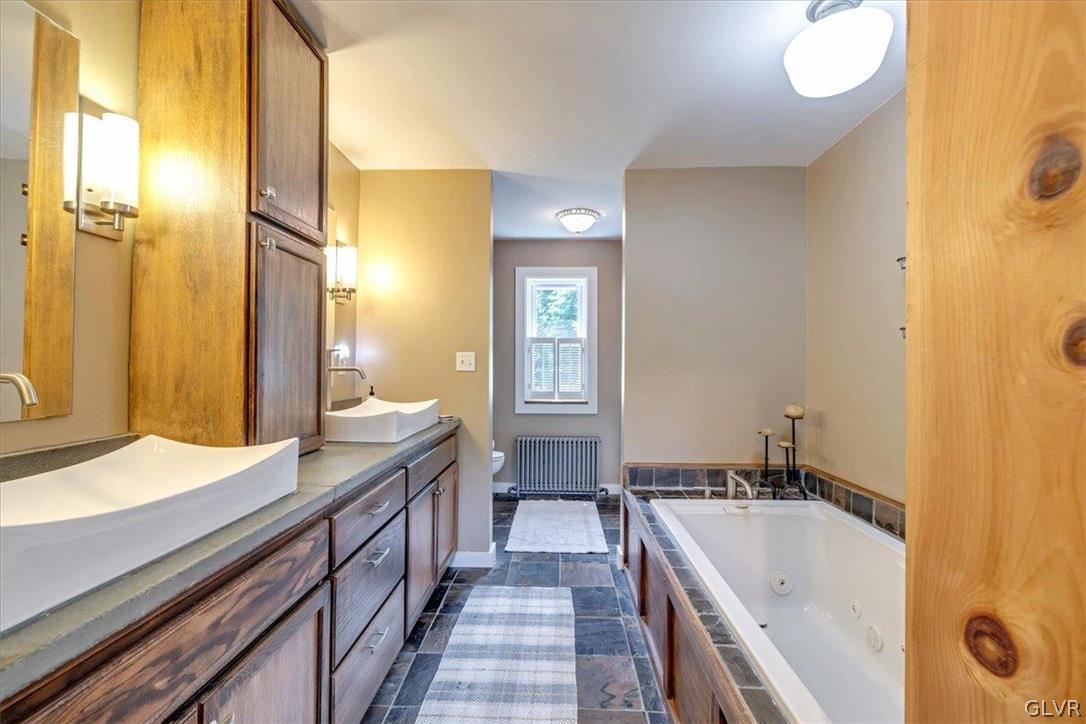 159 Monomonock Road Cresco, PA 18326 - Photo 21 of 50 a bathroom with a double vanity sink and mirror with shower