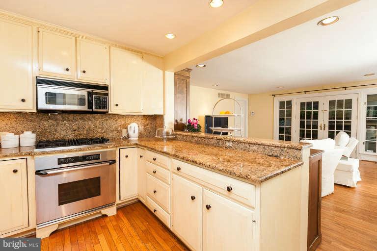 1107 Harriton Road Baltimore, MD 21210 - Photo 14 of 30 a kitchen with granite countertop a stove sink and microwave