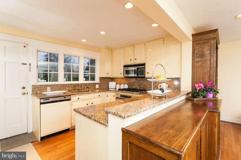 1107 Harriton Road Baltimore, MD 21210 - Photo 15 of 30 a kitchen with stainless steel appliances granite countertop a sink stove and refrigerator