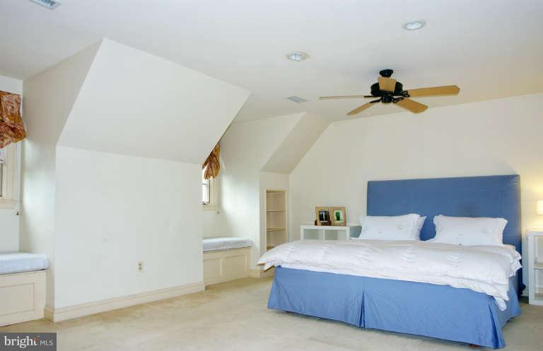 1107 Harriton Road Baltimore, MD 21210 - Photo 17 of 30 a bedroom with a bed and a chandelier fan