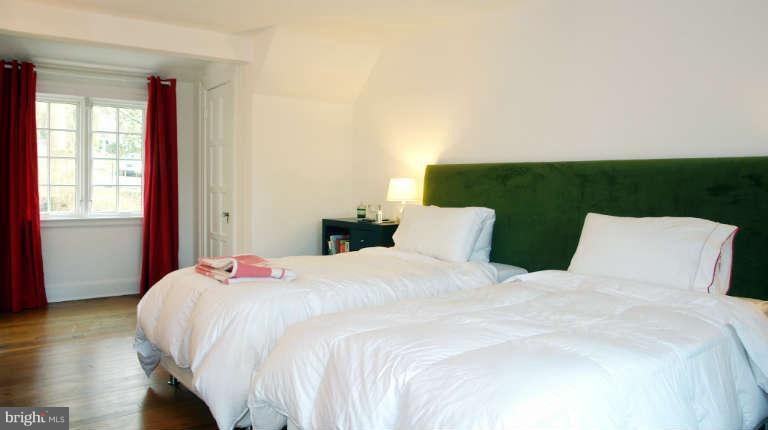 1107 Harriton Road Baltimore, MD 21210 - Photo 19 of 30 a large bed sitting in a bedroom next to a window