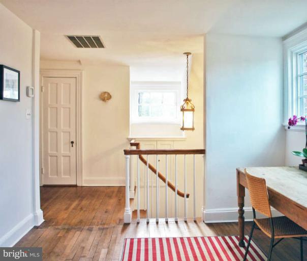 1107 Harriton Road Baltimore, MD 21210 - Photo 23 of 30 a view of a hallway with wooden floor and stairs