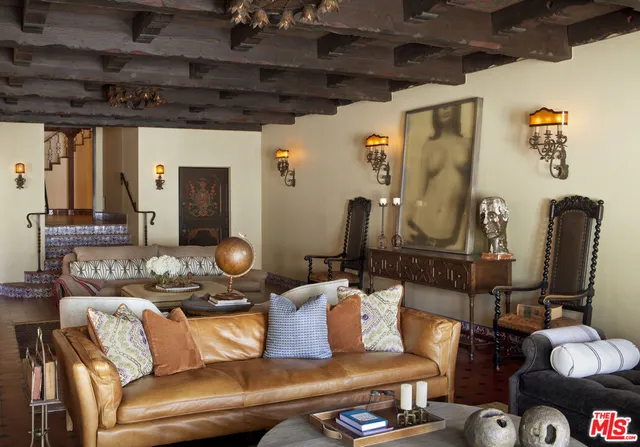 a living room with couch and a potted plant