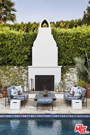 a flower garden is sitting in front of house