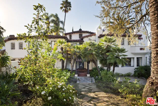 a flower garden is sitting in front of house