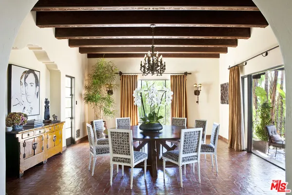 a living room with furniture and potted plants