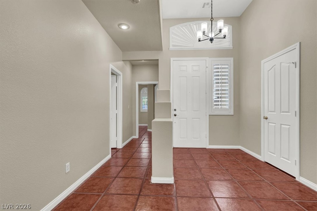 7308 Rustic Meadow Street Las Vegas, NV 89131 - Photo 10 of 27 A welcoming entry hall with gleaming tile floors and a charming chandelier provides an inviting first impression.