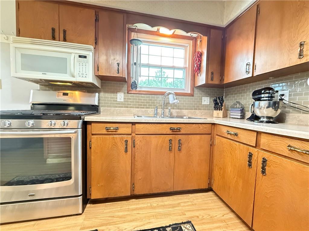 558 Clay Furnace Road Sharpsville, PA 16150 - Photo 29 of 49 a kitchen with stainless steel appliances granite countertop a stove a sink and a microwave