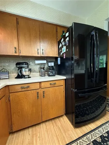 a view of a refrigerator a sink and dishwasher
