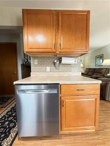 a kitchen with stainless steel appliances a stove a sink and white cabinets