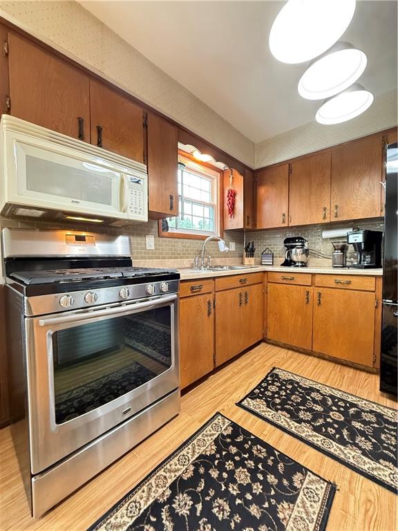558 Clay Furnace Road Sharpsville, PA 16150 - Photo 32 of 49 a kitchen with stainless steel appliances a stove a sink and white cabinets