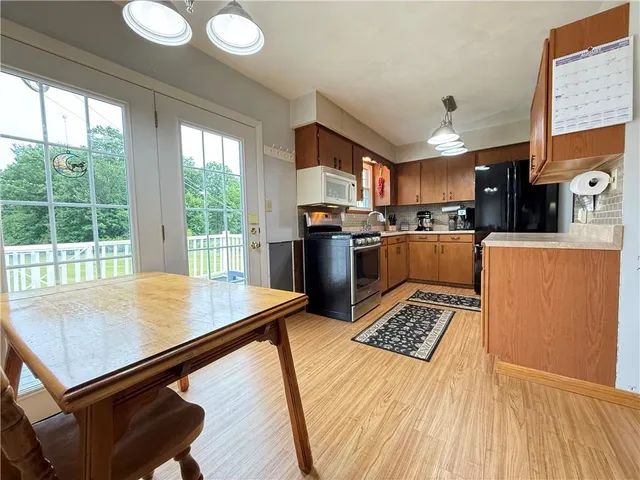 a kitchen with a sink stove top oven and cabinets