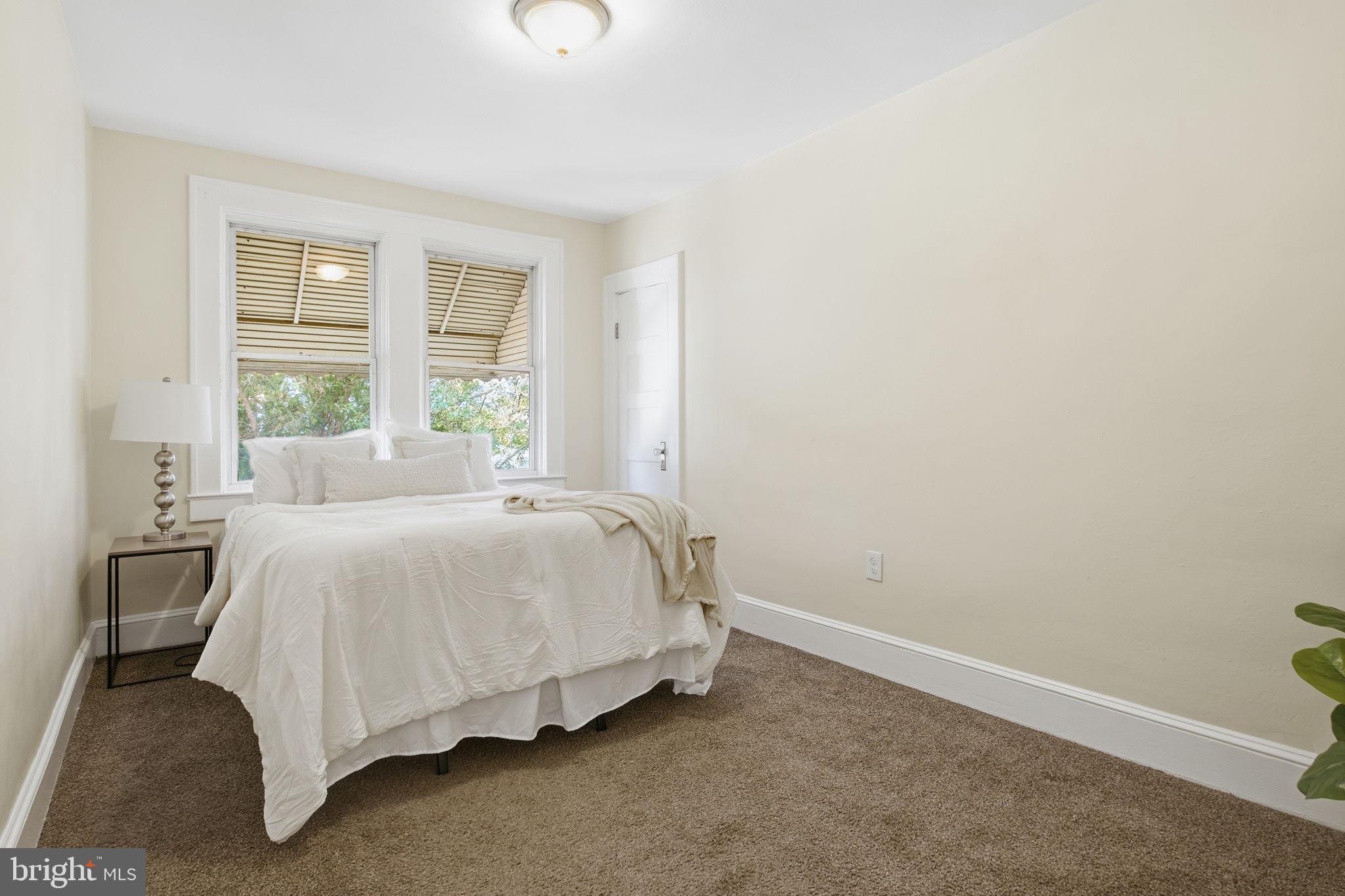 2803 Berwick Avenue Baltimore, MD 21234 - Photo 14 of 25 a bed sitting in a bedroom next to a window