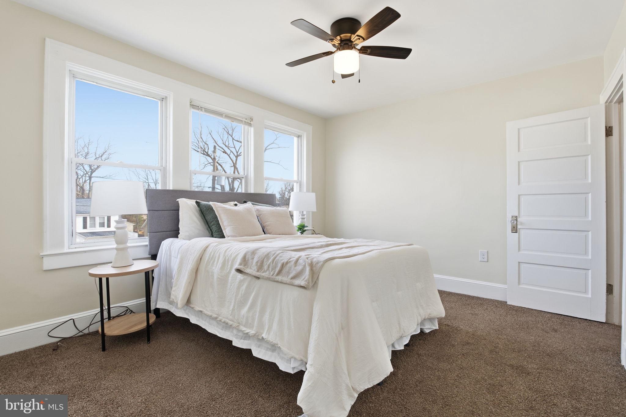 2803 Berwick Avenue Baltimore, MD 21234 - Photo 16 of 25 a bedroom with a bed chandelier and a window