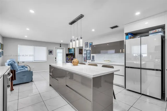 a kitchen with stainless steel appliances a sink stove and refrigerator