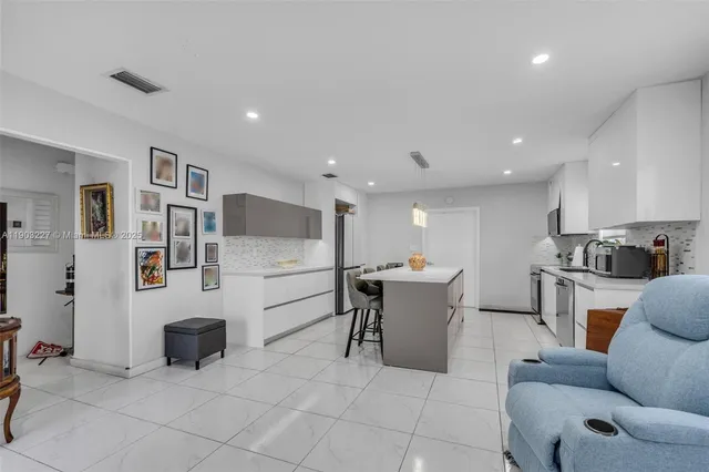 a living room with furniture a dining table and chairs