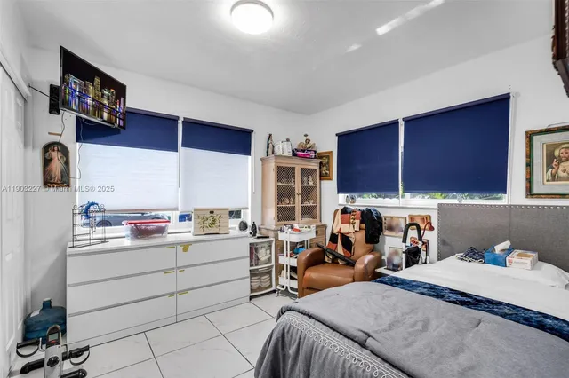 a bed room with a bed and a television