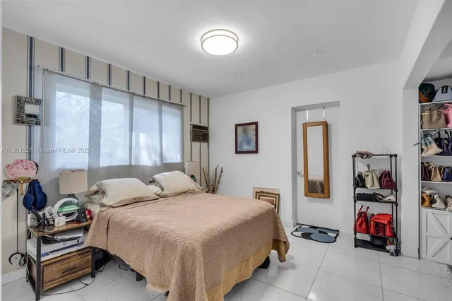 a bedroom with a bed a couch and a book shelf