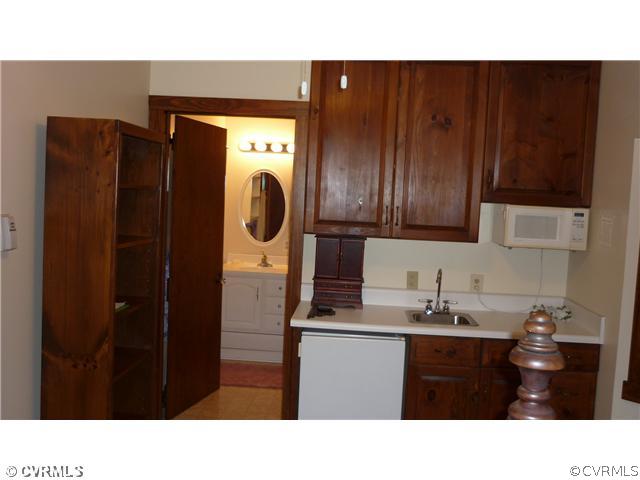 2018 Esquire Road Richmond, VA 23235 - Photo 5 of 7 a bathroom with a sink a mirror and cabinets