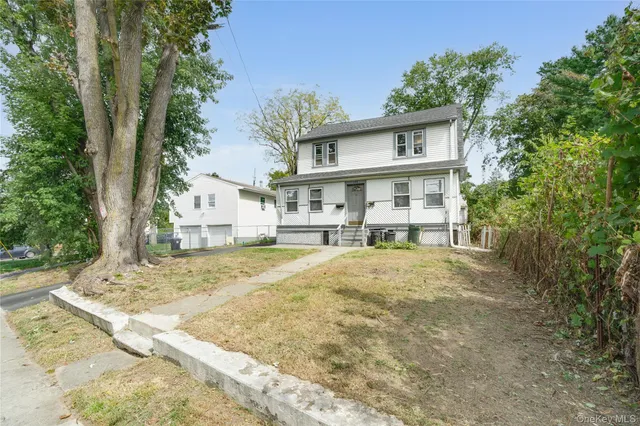 a front view of a house with a yard